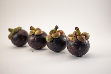 Four mangosteens isolated on white background