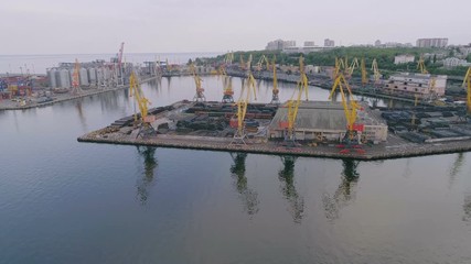 Aerial of industrial seaport with zigzag platform, cranes and deport in Odessa