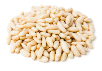 A heap of pine nuts on a white background