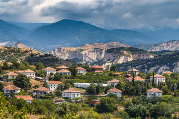 View of Bulgarian ski resort Bansko at summer time, peaks of Pirin mountains in the background.