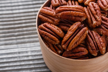 delicious pecan nuts on a rustic wooden background