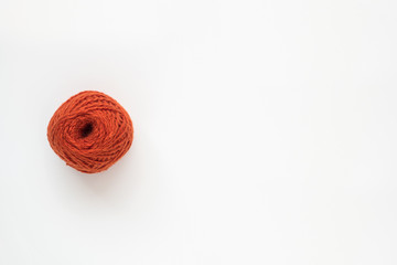 Orange ball of wool yarn isolated on white background. Flat lay, top view