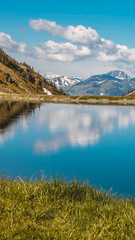 Fototapeta na wymiar Smartphone HD wallpaper of beautiful alpine view with reflections at Leogang - Tyrol - Austria