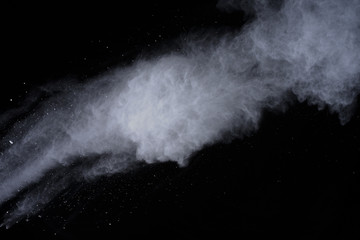 Fototapeta na wymiar White powder explosion on black background. Dust splatted isolated. Paint Holi.