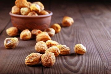 Dry apricot on a dark wooden background.