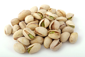 Salted pistachios on a white isolate.