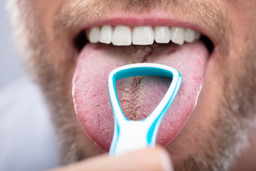 Man Cleaning His Tongue