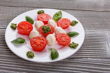 Caprese salad on a wooden rustic background