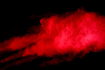 abstract red powder explosion on black background.abstract red powder splatted on black background. Freeze motion of red powder exploding.