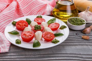 Caprese salad on a wooden rustic background