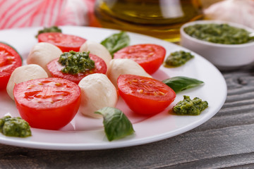 Caprese salad on a wooden rustic background