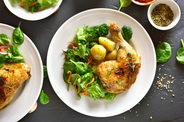Baked chicken leg with potato and green salad