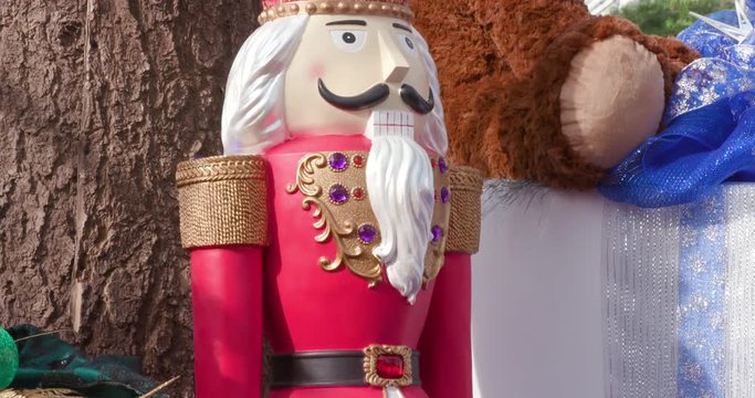 Large Red Nutcracker Standing Among Presents
