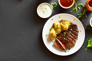 Sliced medium rare roast beef with potato
