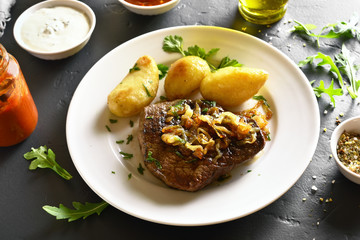 Sliced medium rare roast beef with potato