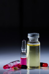 Powders, pills, liquid in ampoules. Chemical drugs types: Addiction concept on black background. low key photo