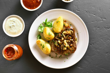 Sliced medium rare roast beef with potato