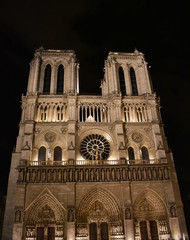 Fototapeta na wymiar Notre Dame Cathedral at midnight. Facade, towers, rose window, archs and statues. Paris, France.