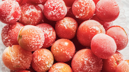Frozen tomatoes covered with hoarfrost. close-up.