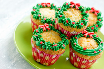Christmas wreath cupcakes, homemade cupcakes decorated for winter holidays, traditional sweet treat for kids
