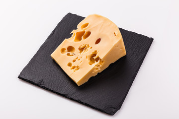 Piece and slices of cheese on a white background