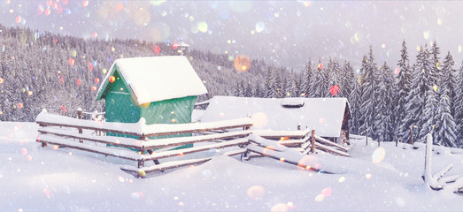 Fototapeta na wymiar Fantastic winter landscape with wooden house in snowy mountains. Christmas holiday postcard collage. DOF bokeh light postprocessing effect