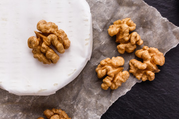 delicious creamy camembert cheese on a wooden rustic background