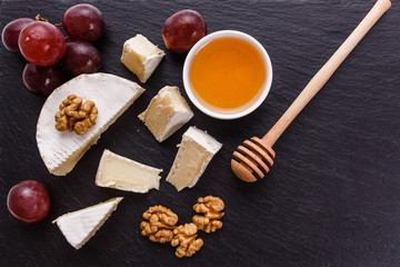 delicious creamy camembert cheese on a wooden rustic background