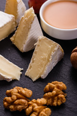 delicious creamy camembert cheese on a wooden rustic background