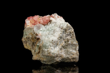 Macro of the mineral stone Rhodochrosite with fluorite on a black background