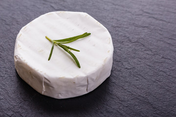 delicious creamy camembert cheese on a wooden rustic background