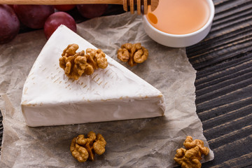 delicious creamy camembert cheese on a wooden rustic background