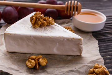 delicious creamy camembert cheese on a wooden rustic background