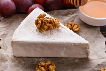 delicious creamy camembert cheese on a wooden rustic background