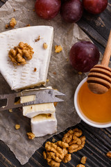 delicious creamy camembert cheese on a wooden rustic background