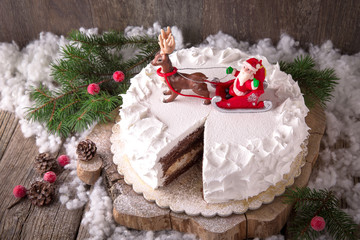 Happy New Year Cake. Christmas cake clock, decorated with Christmas tree figures, bears, deer, Christmas tree, sledges, gifts, a train, a snowman, snowflakes, stars