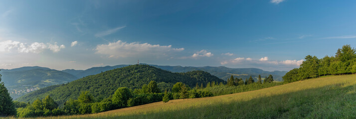 Evening in national park Pieniny with sunny shine over green meadows