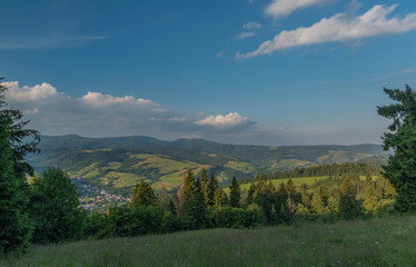 Evening in national park Pieniny with sunny shine over green meadows