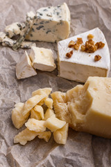 set of different cheeses on a wooden rustic background