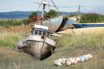 Abandoned shipwreck in a boat graveyard in Homer Spit Alaska