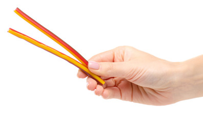 Jelly candy sticks in hand on a white background. Isolation