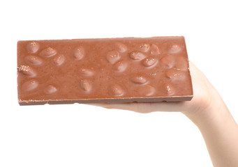 A bar of chocolate with almonds in hand on a white background isolation