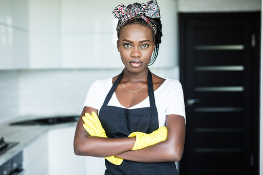 Young African Woman With Arms Crossed Before Cleaning In The Kitchen