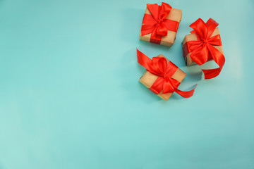 Christmas border. Christmas gifts, fir branches on blue background. Flat lay, top view, copy space