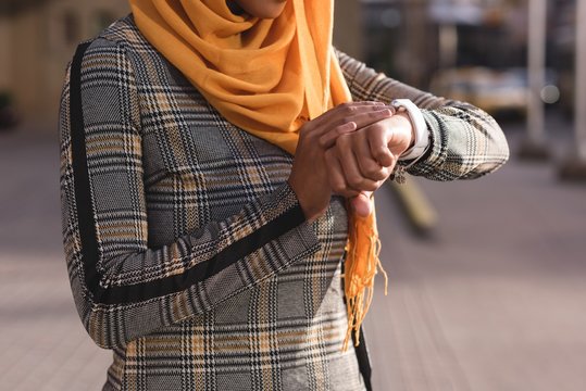 Woman using smart watch in city