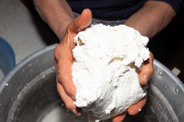 preparation of home-made cheese by an elderly housewife