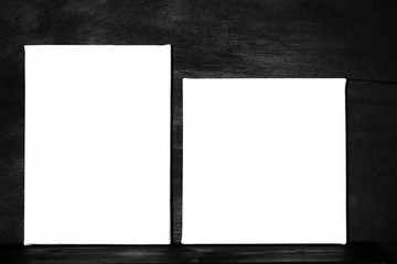 Two white empty canvas on black. Posters template.