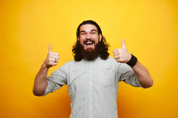 Excited berded man with long hair express his opinion and gesture with hands