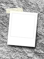 Blank square instant photo frame on rough concrete wall background