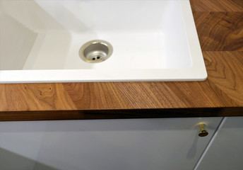 Sink for washing dishes in the kitchen. Kitchen table with cupboard